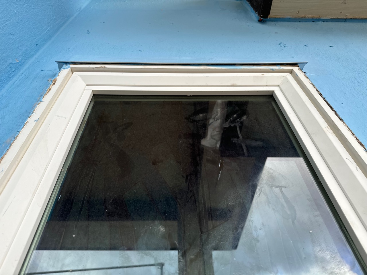 Close view of window head flashing during waterproofing repair