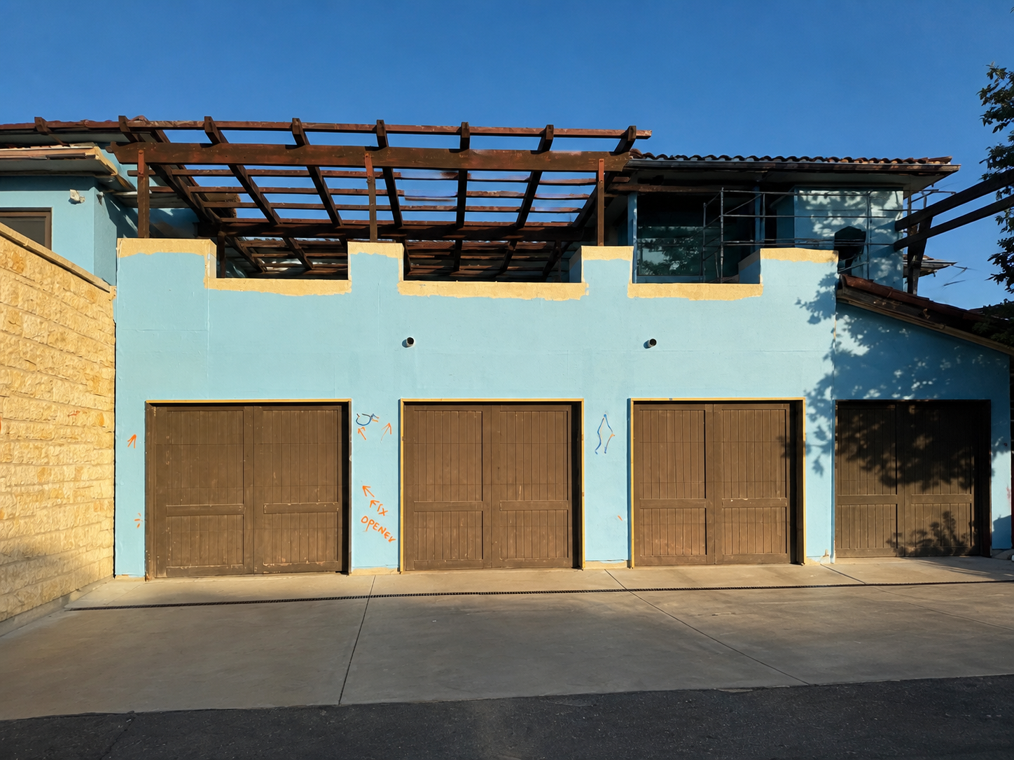 Garage facade after blue waterproofing was applied over the sheathing